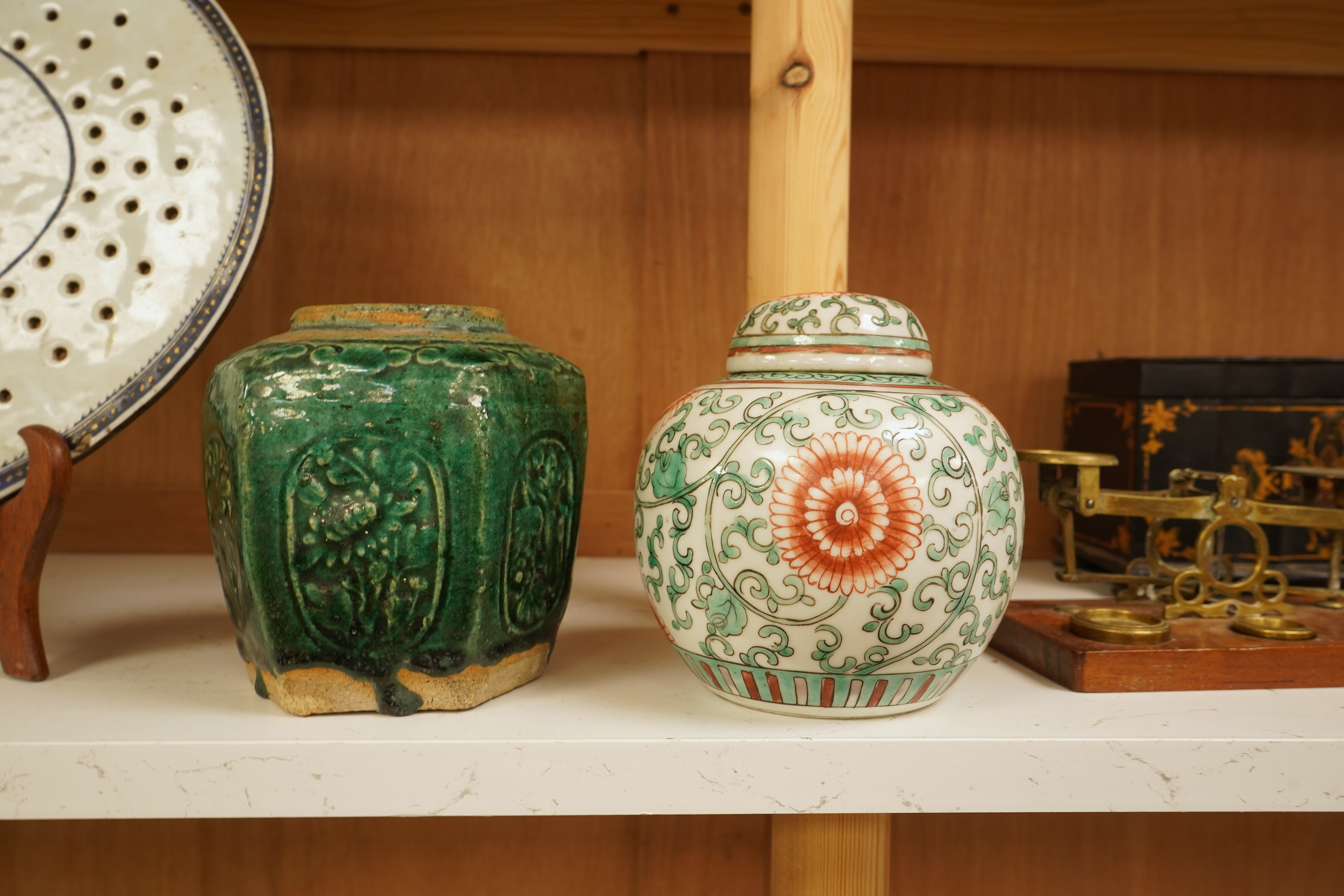A Chinese famille verte jar and cover and a similar green glazed earthenware jar, tallest 13cm